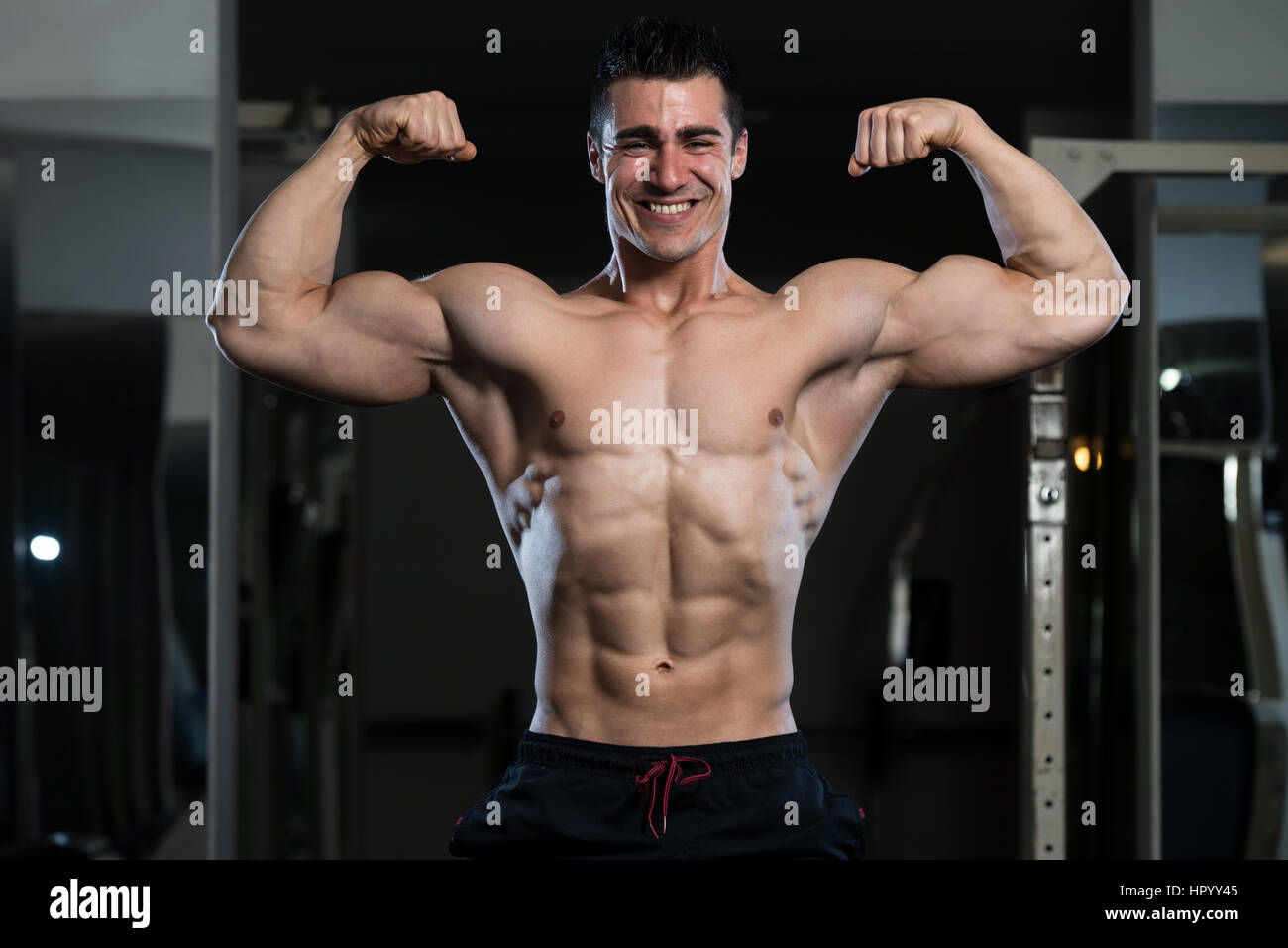 Portrait Of A Young Fit Man Showing Front Double Biceps Pose - Muscular  Athletic Bodybuilder Fitness Model Posing Stock Photo - Alamy