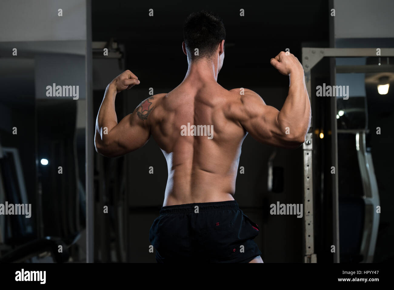 Bodybuilder Posing In Different Poses Demonstrating Their Muscles