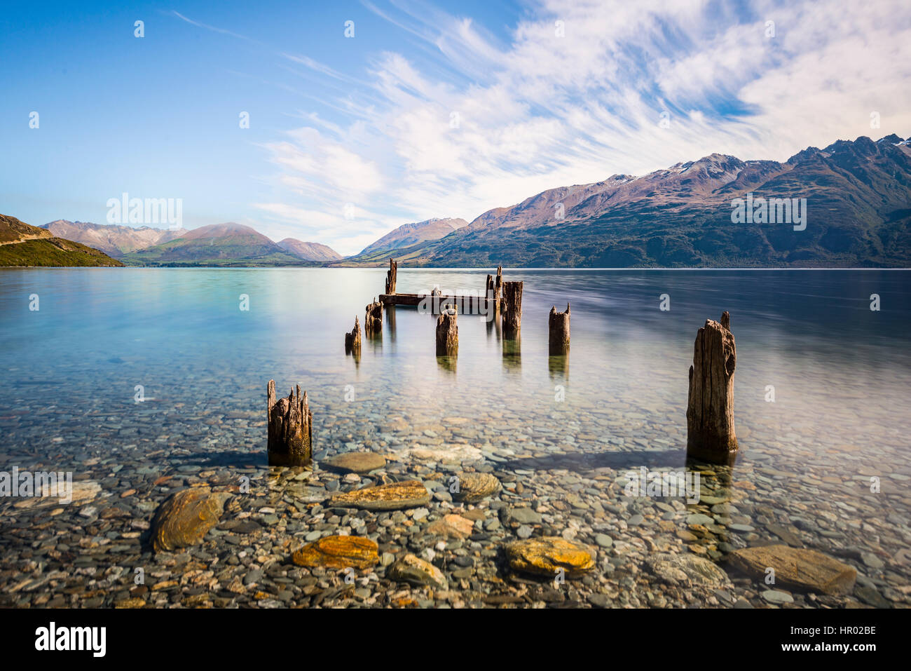 Decayed jetty, old wooden posts in Lake Wakatipu at Glenorchy, Otago Region, Southland, New Zealand Stock Photo