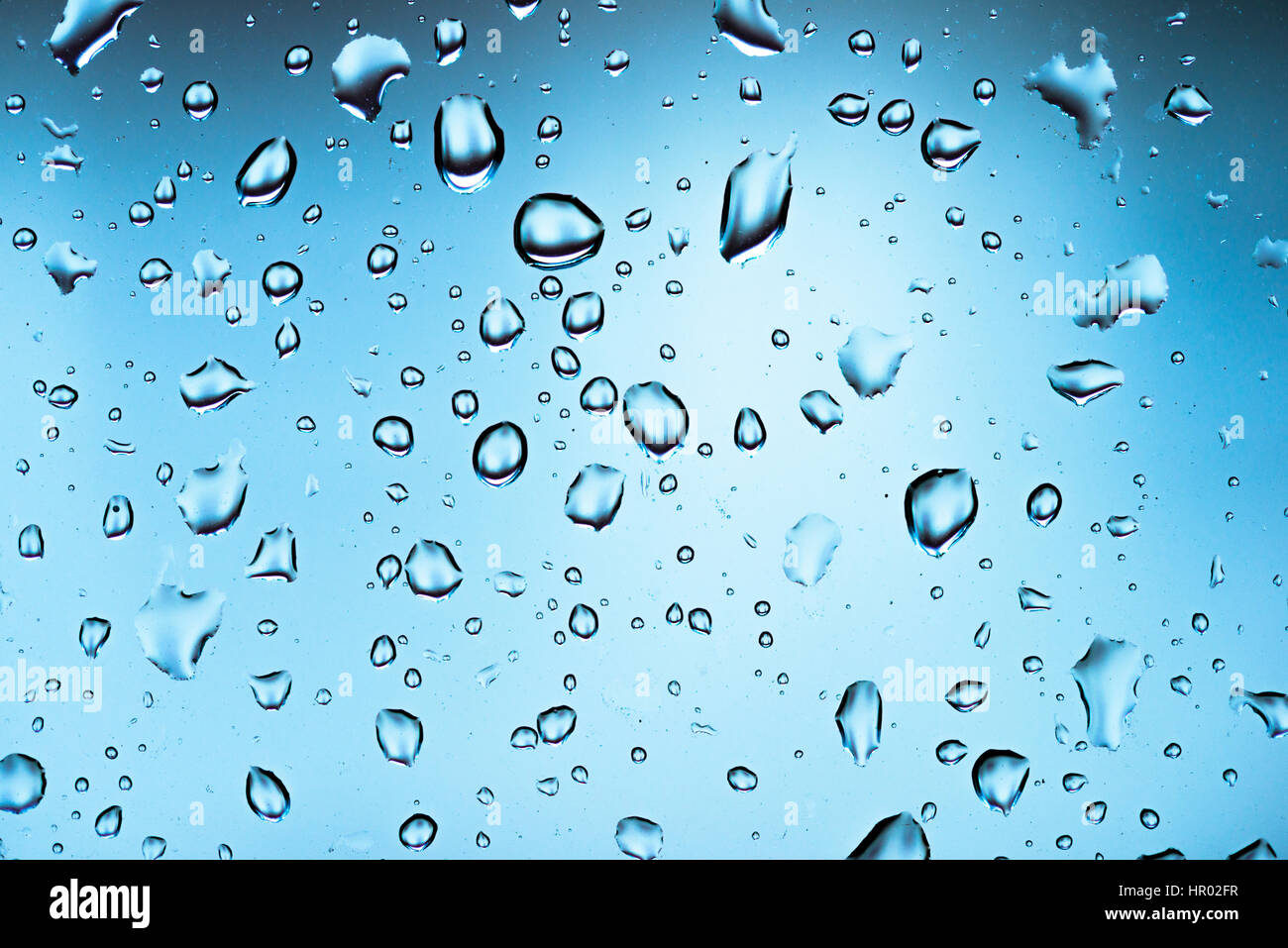 Water drops on a window pane, glass pane, window, rain, bad weather, full-frame, background image Stock Photo