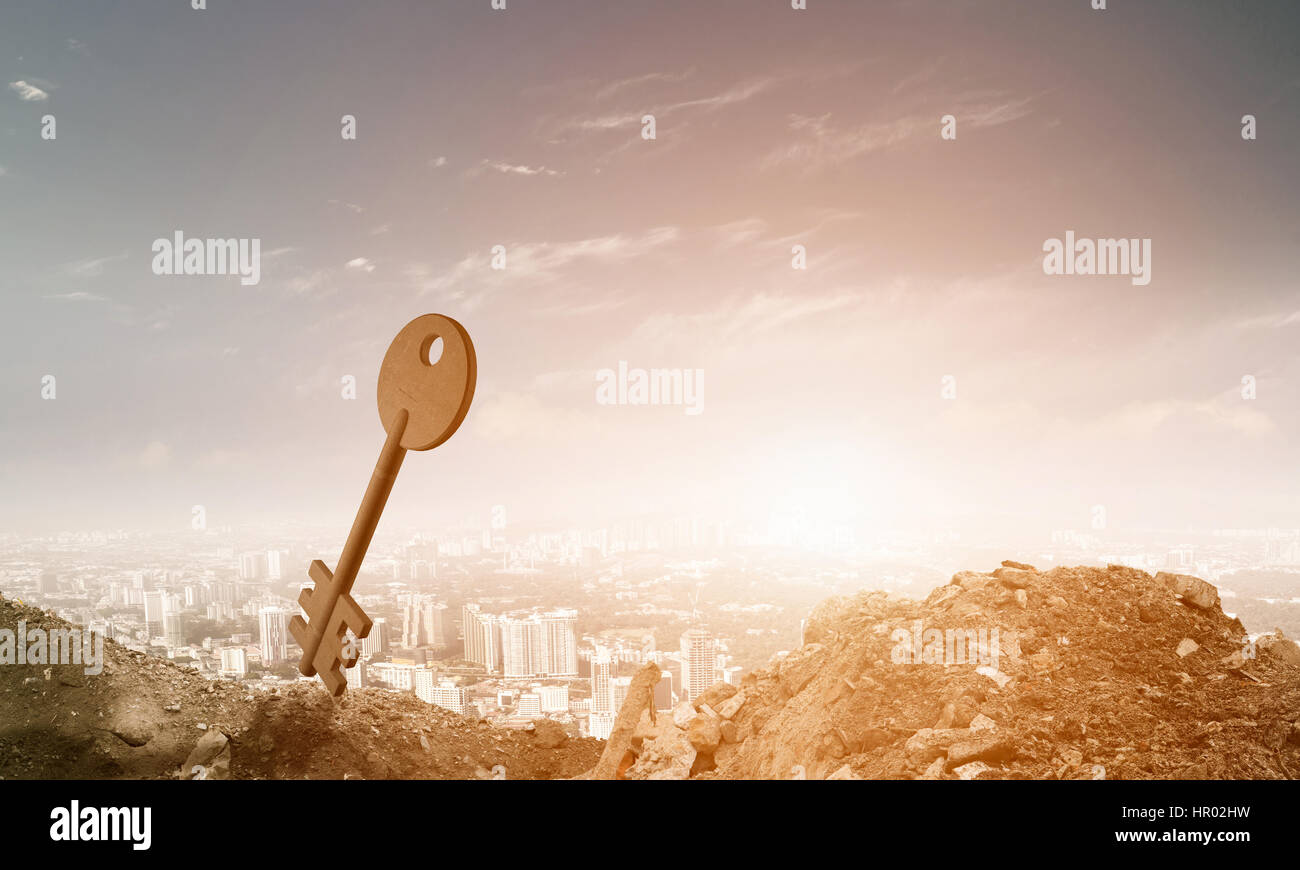 Key stone figure as symbol of access on green hill Stock Photo - Alamy
