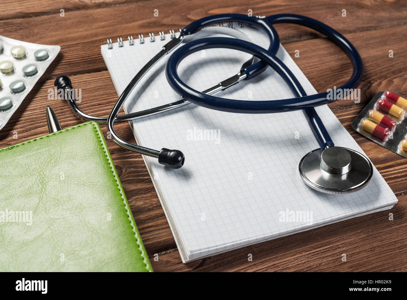 Close view of stethoscope on wooden desk Stock Photo - Alamy