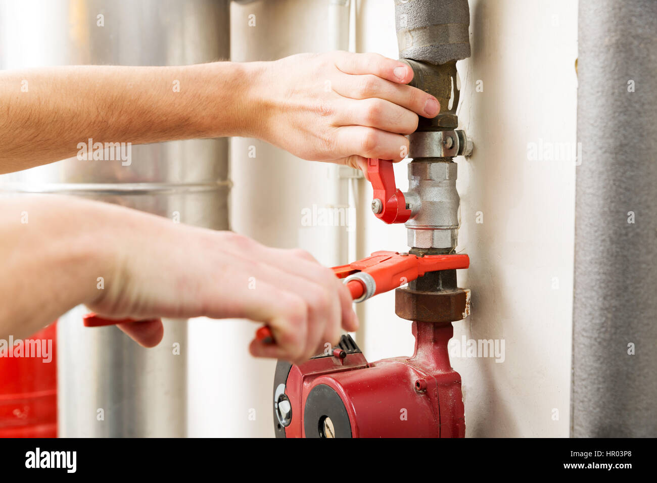 closeup of plumber hands working with pipeline connections Stock Photo