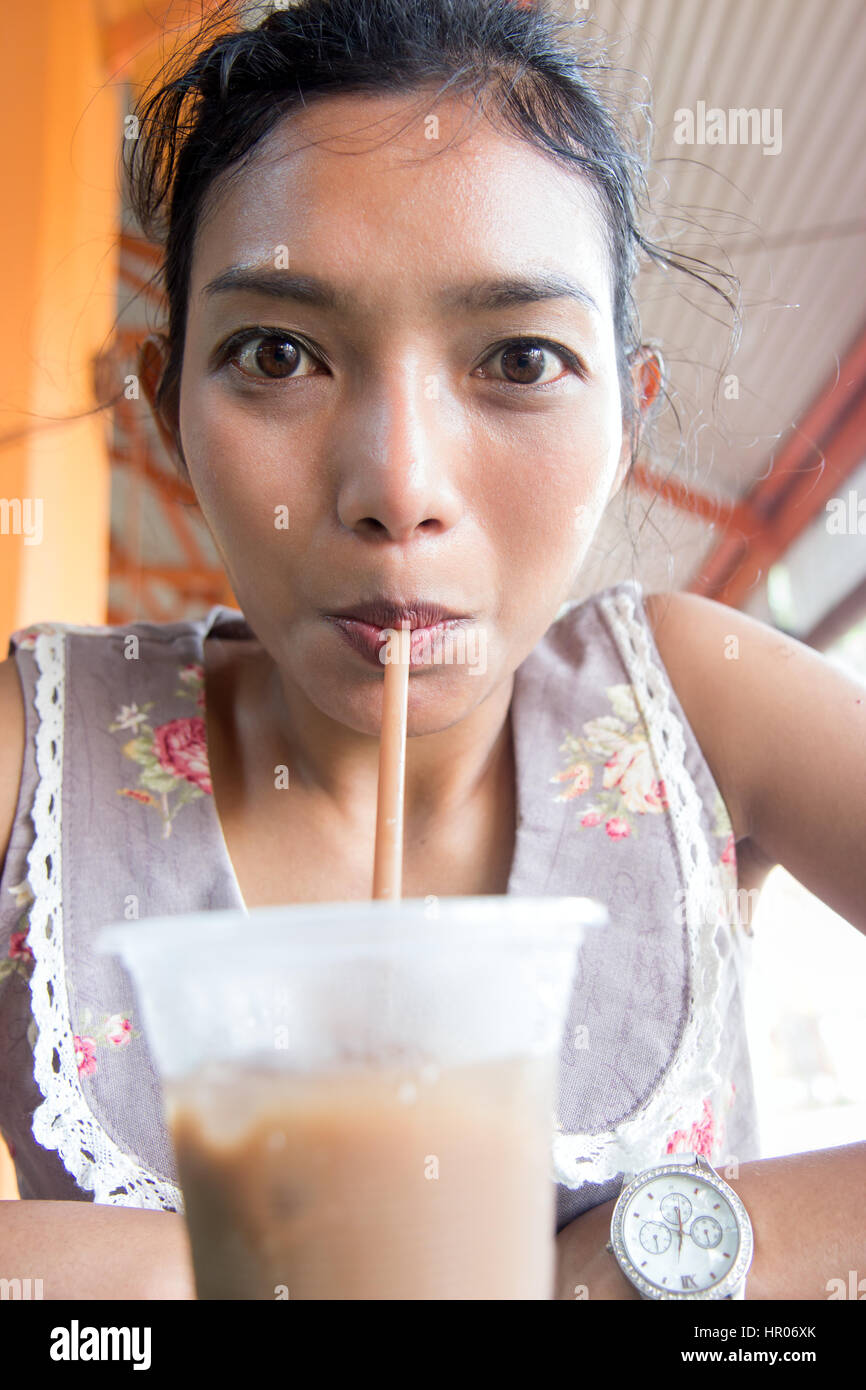 https://c8.alamy.com/comp/HR06XK/portrait-of-a-girl-drinking-iced-coffee-in-a-outdoors-restaurant-cheerful-HR06XK.jpg