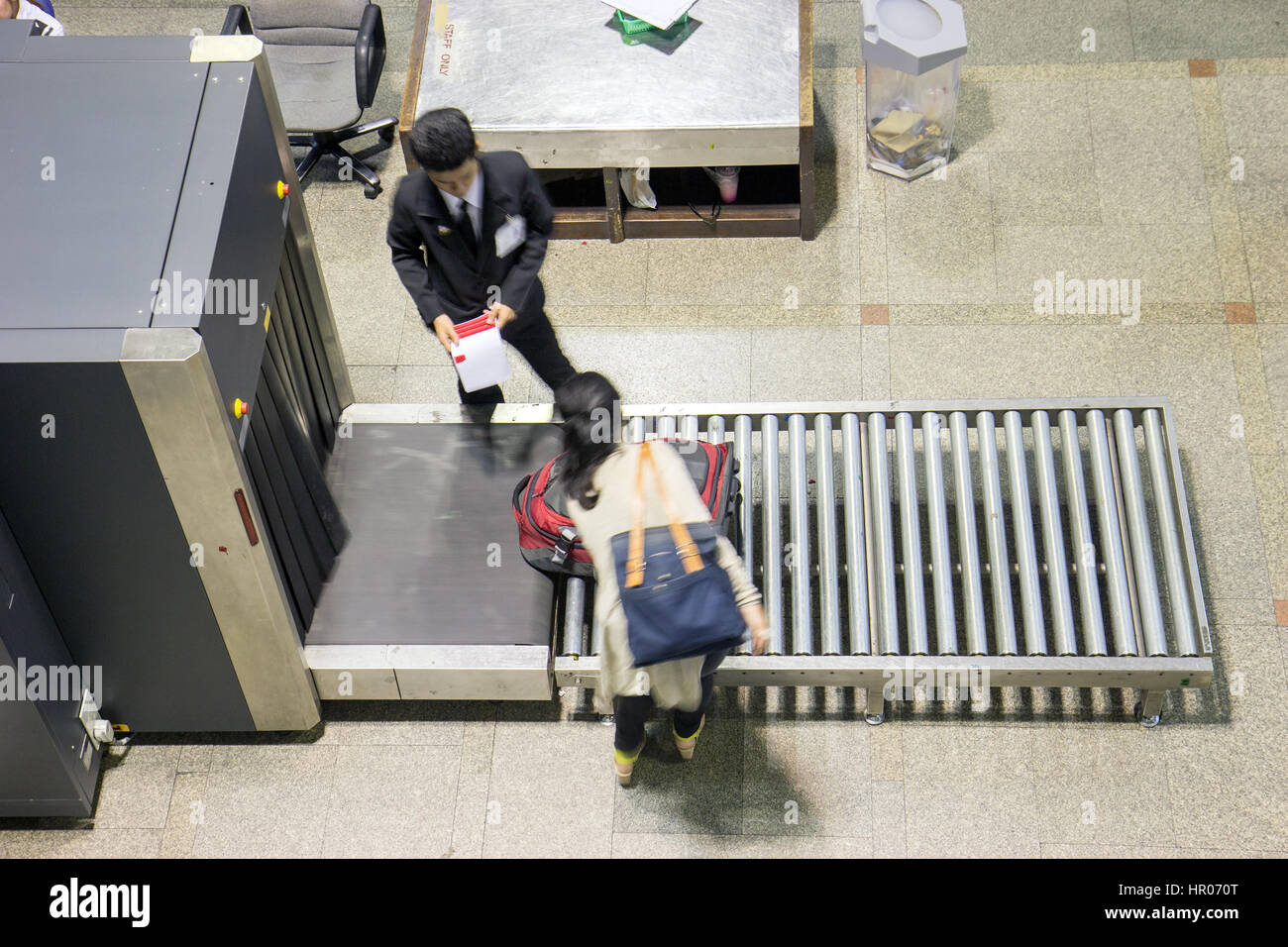 Control baggage at the airport. Airport scanner checked luggage of passengers before departure. Stock Photo