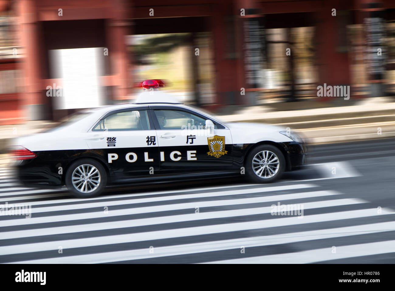 A police car driving on city streets, Tokyo Stock Photo