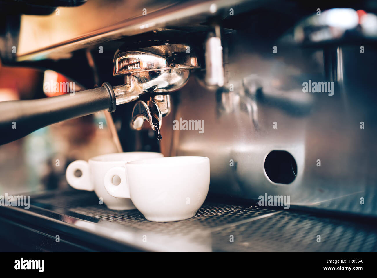 Professional coffee brewing. Espresso machine preparing and pouring two perfect cups of coffee