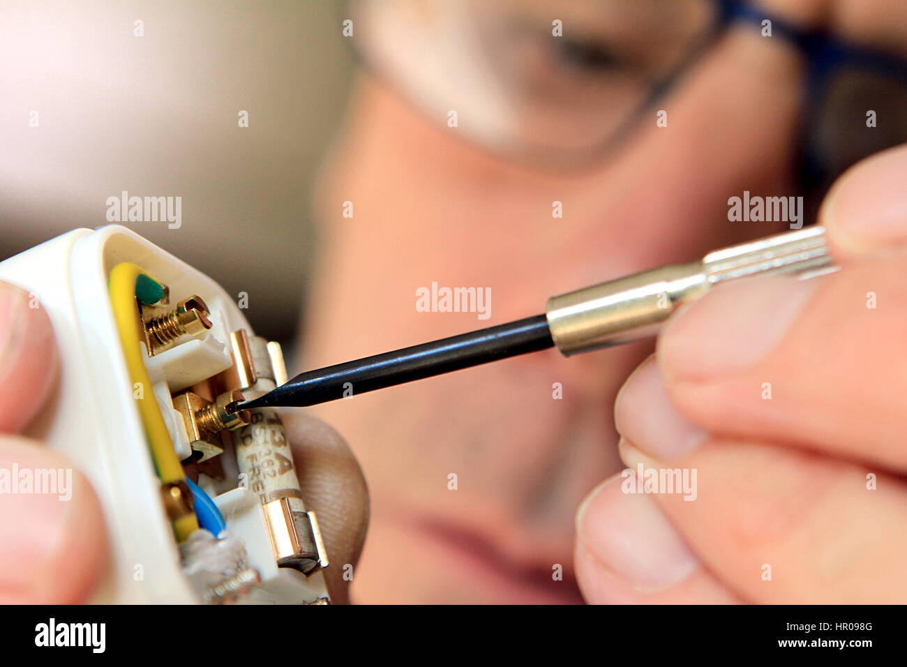 Electrician rewiring a UK 13 amp domestic electric plug Stock Photo Alamy