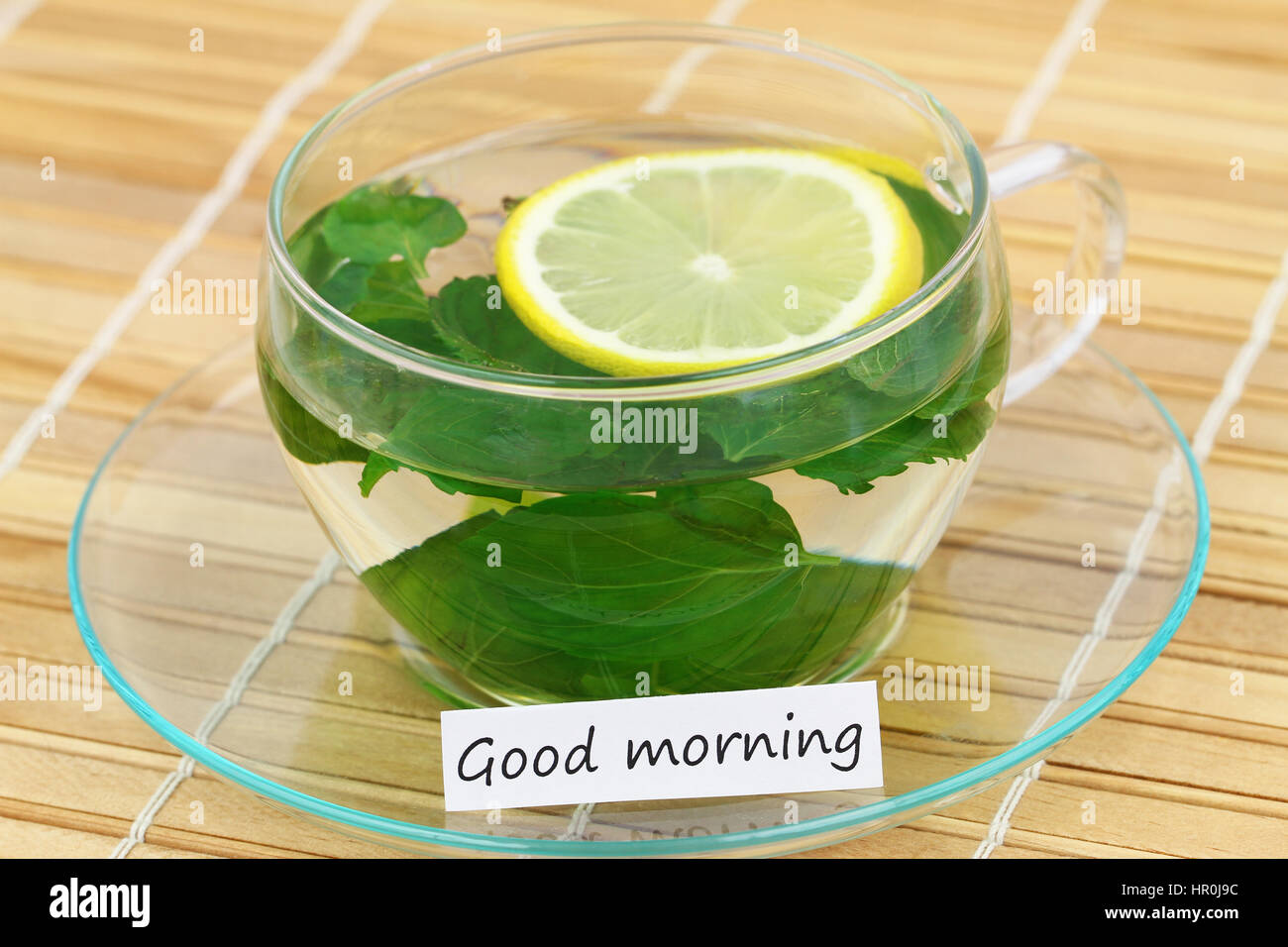 Good morning card with cup of mint tea with lemon on bamboo mat Stock Photo