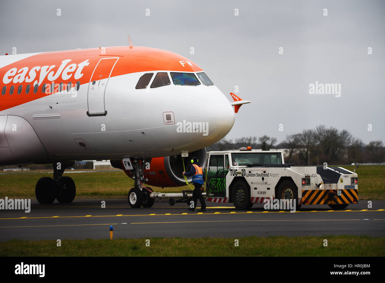 easyJet Airbus plane A319-111 at London Southend Airport being pushed into position for starting by a Schopf F110 tractor tug called Anna by Stobart Stock Photo