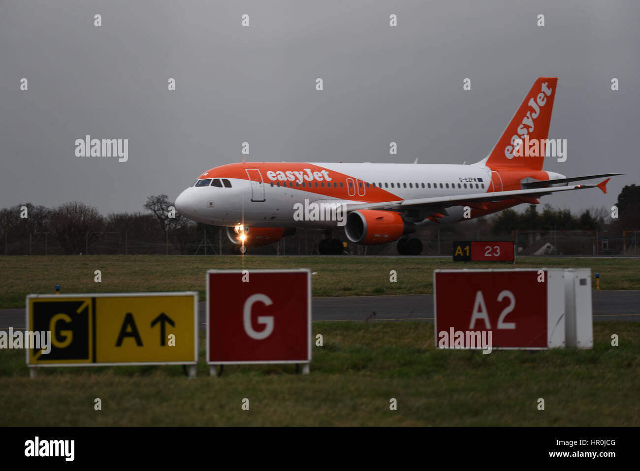 easyJet Airbus plane A319-111 G-EZFW at London Southend Airport holding for take off clearance behind taxiway and runway marker signs Stock Photo