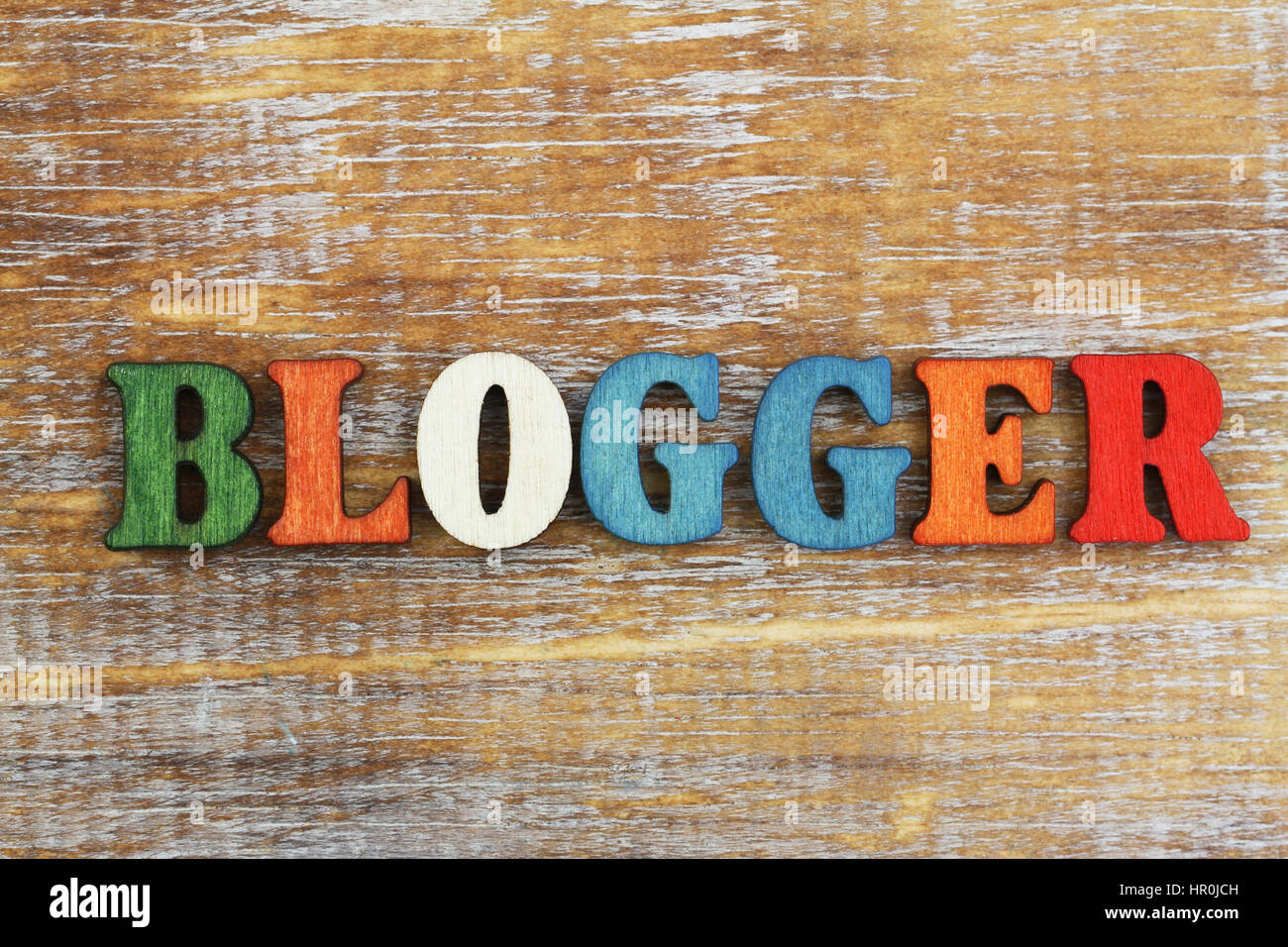 Blogger written with colorful letters on rustic wooden surface Stock Photo