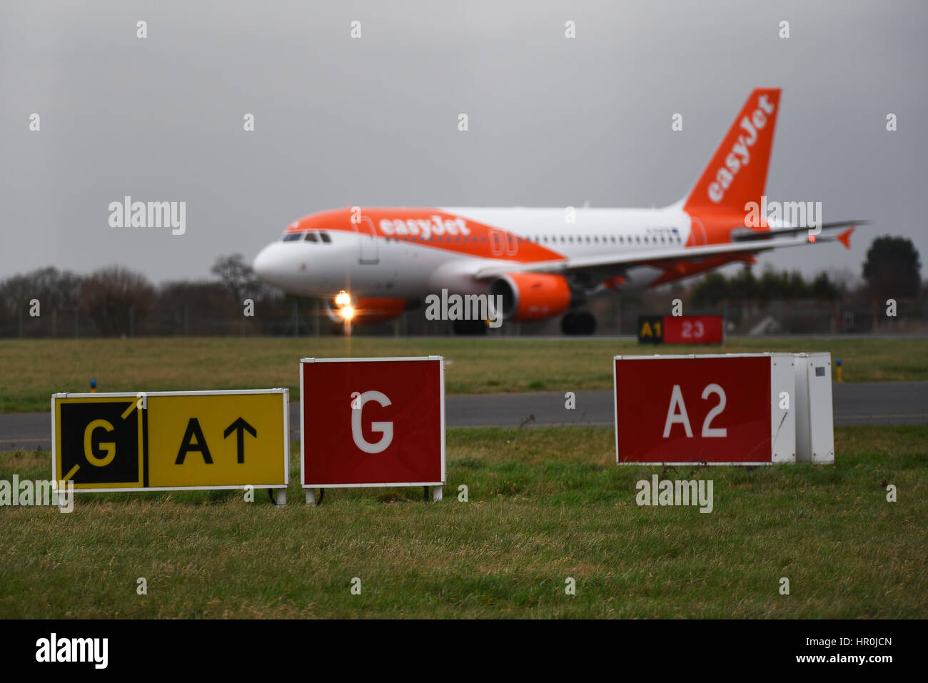 easyJet Airbus plane A319-111 G-EZFW at London Southend Airport holding for take off clearance behind taxiway and runway marker signs. Space for copy Stock Photo
