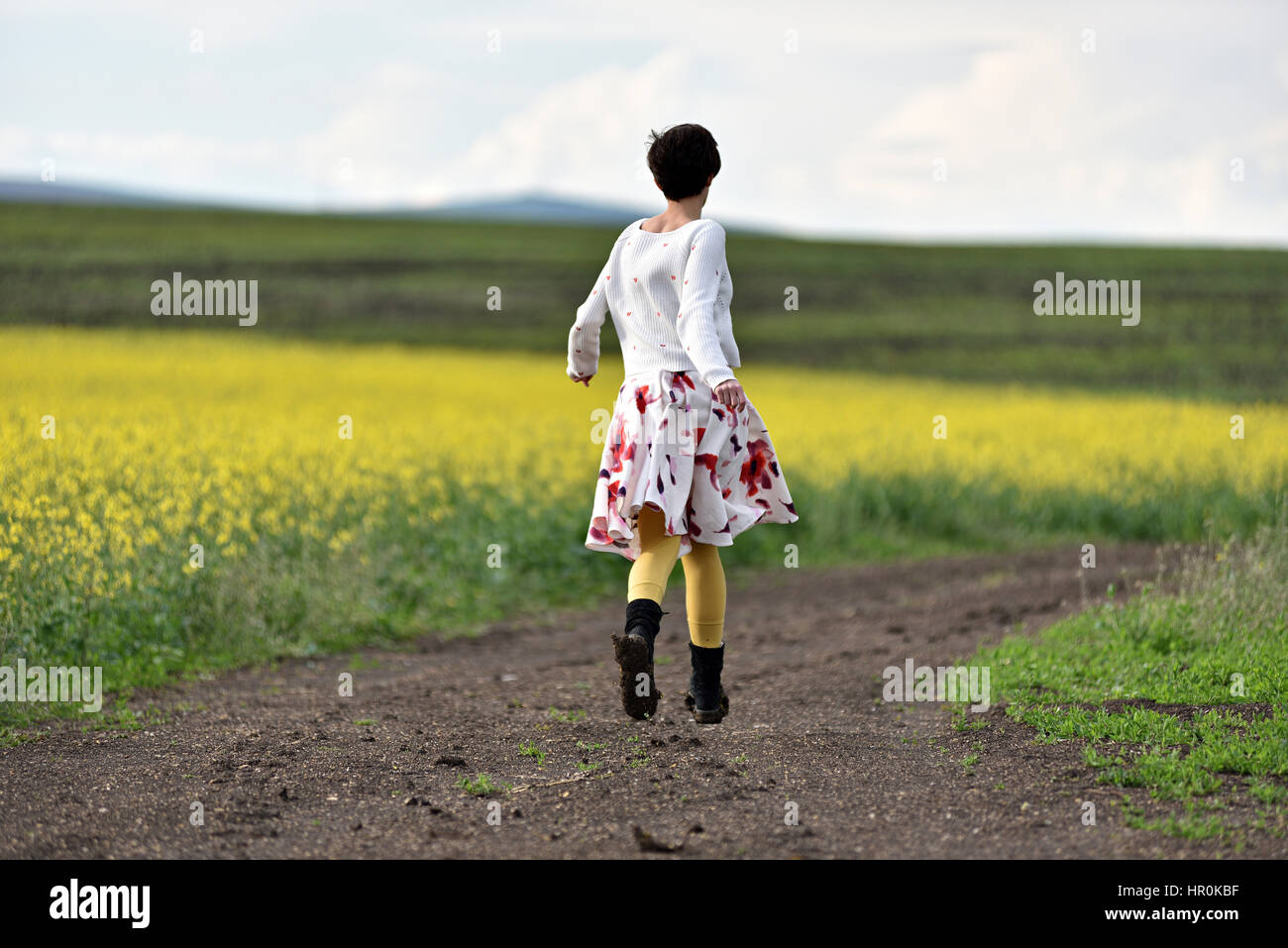 Young woman running on a countryside road. Freedom concept Stock Photo ...