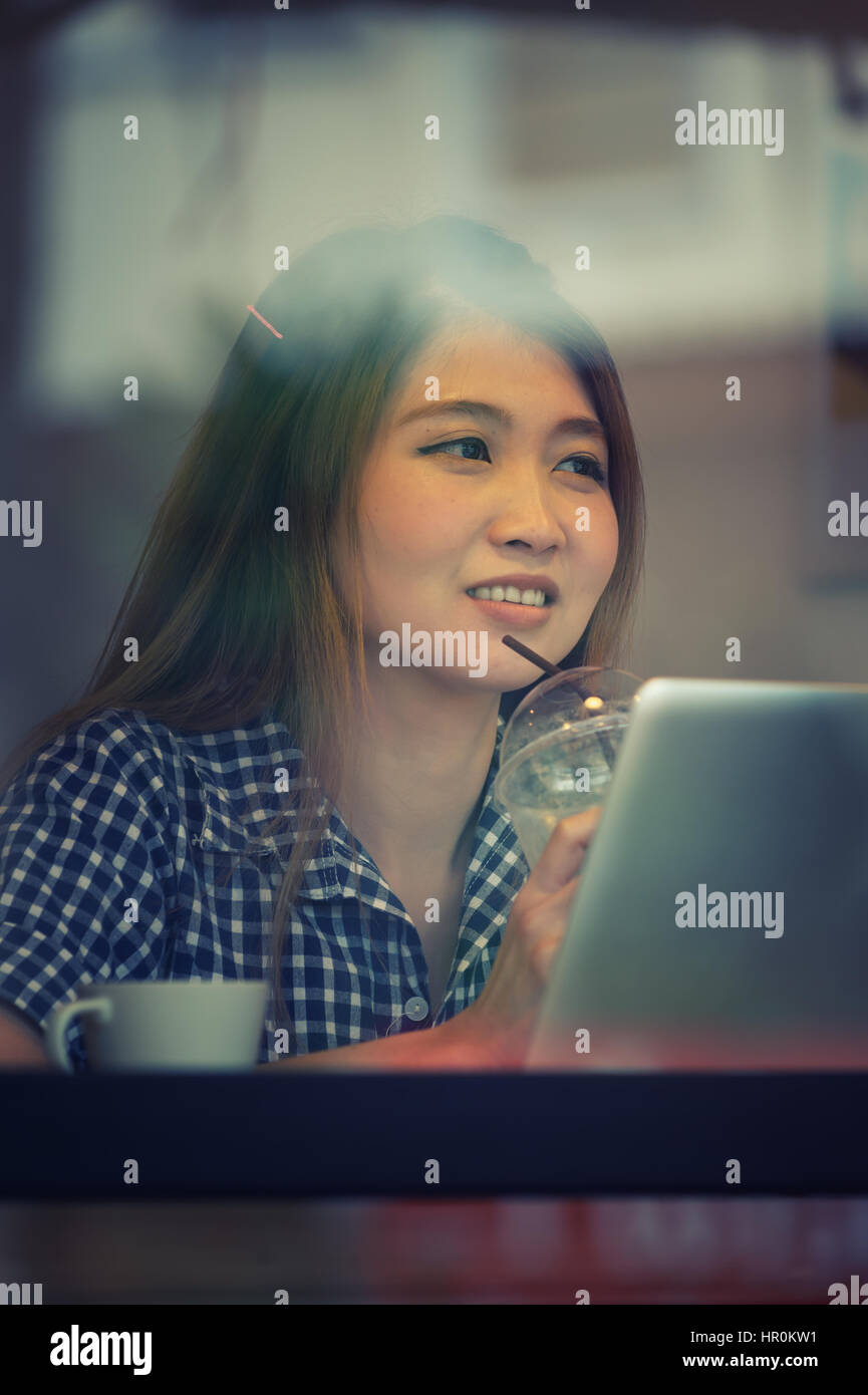 Portrait asia young woman working on laptop in coffee shop, Vacations ...