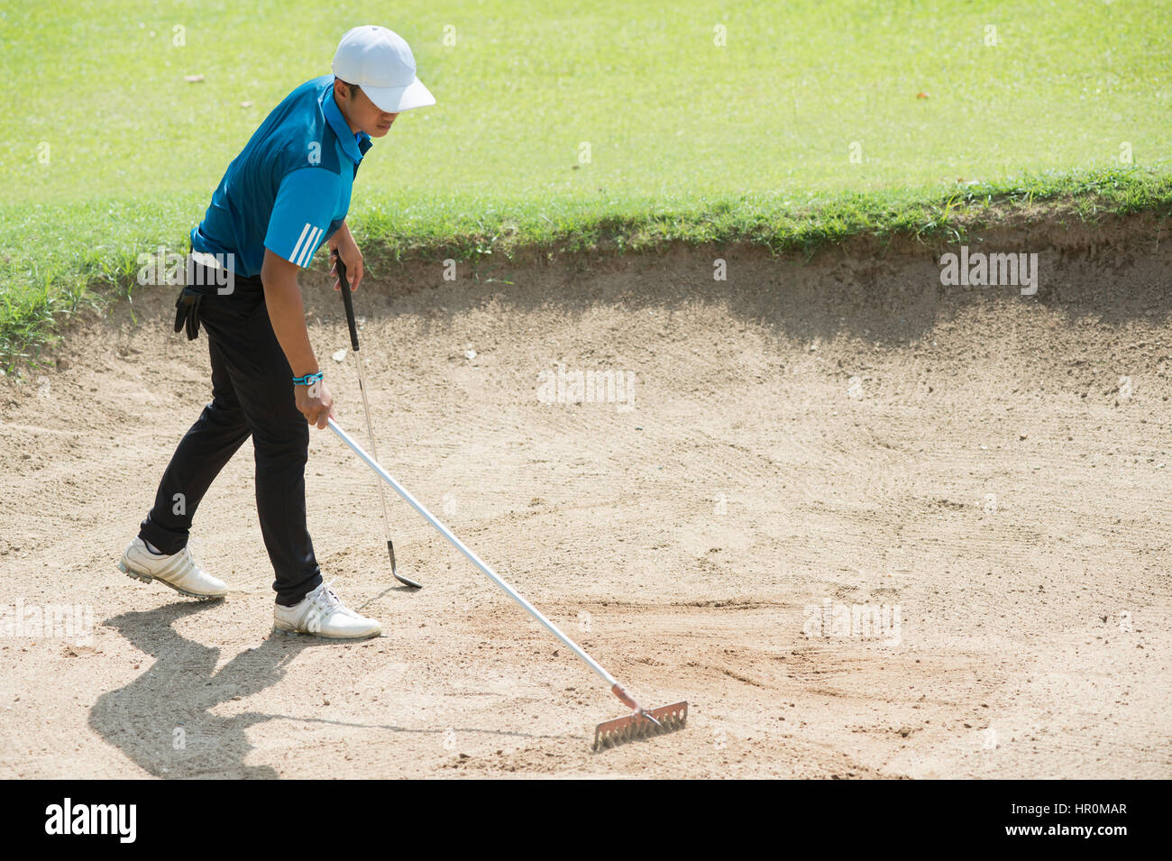 golfer racking sand at golf course, in thailand Stock Photo - Alamy
