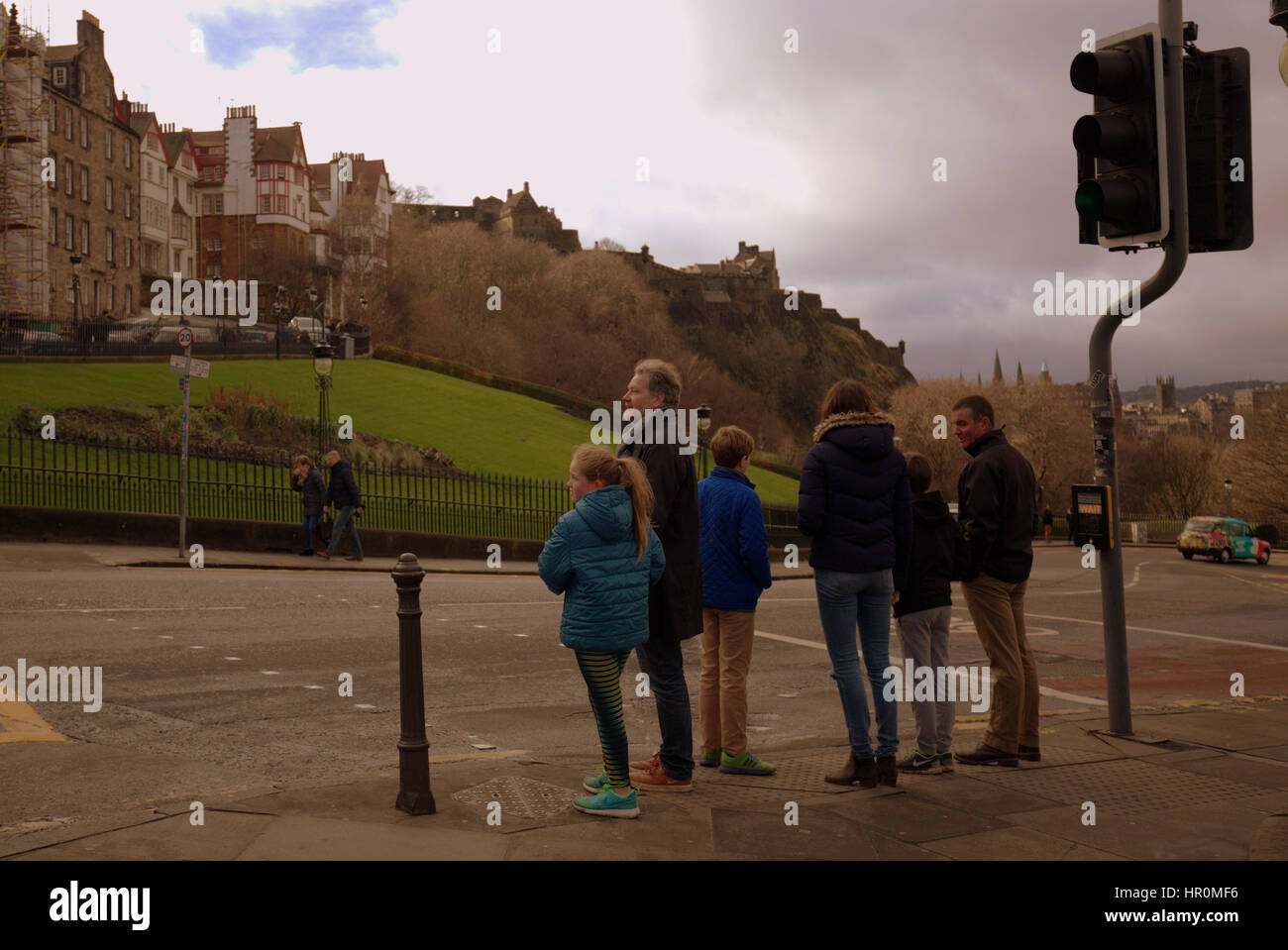 Edinburgh the mound family of  tourists at traffic lights  walking on the street s Stock Photo