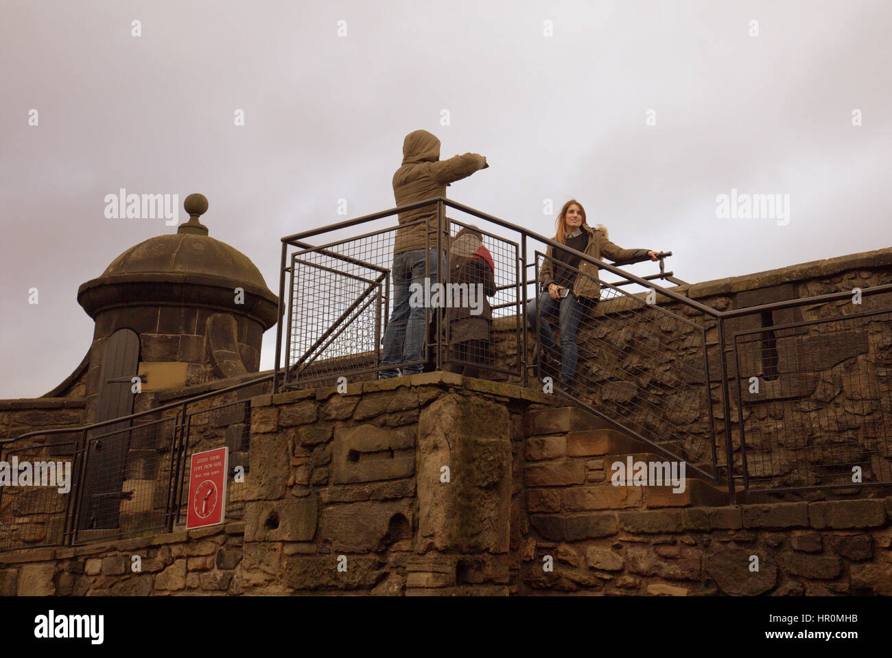 Edinburgh castle tourists on the ramparts inside the castle taking ...