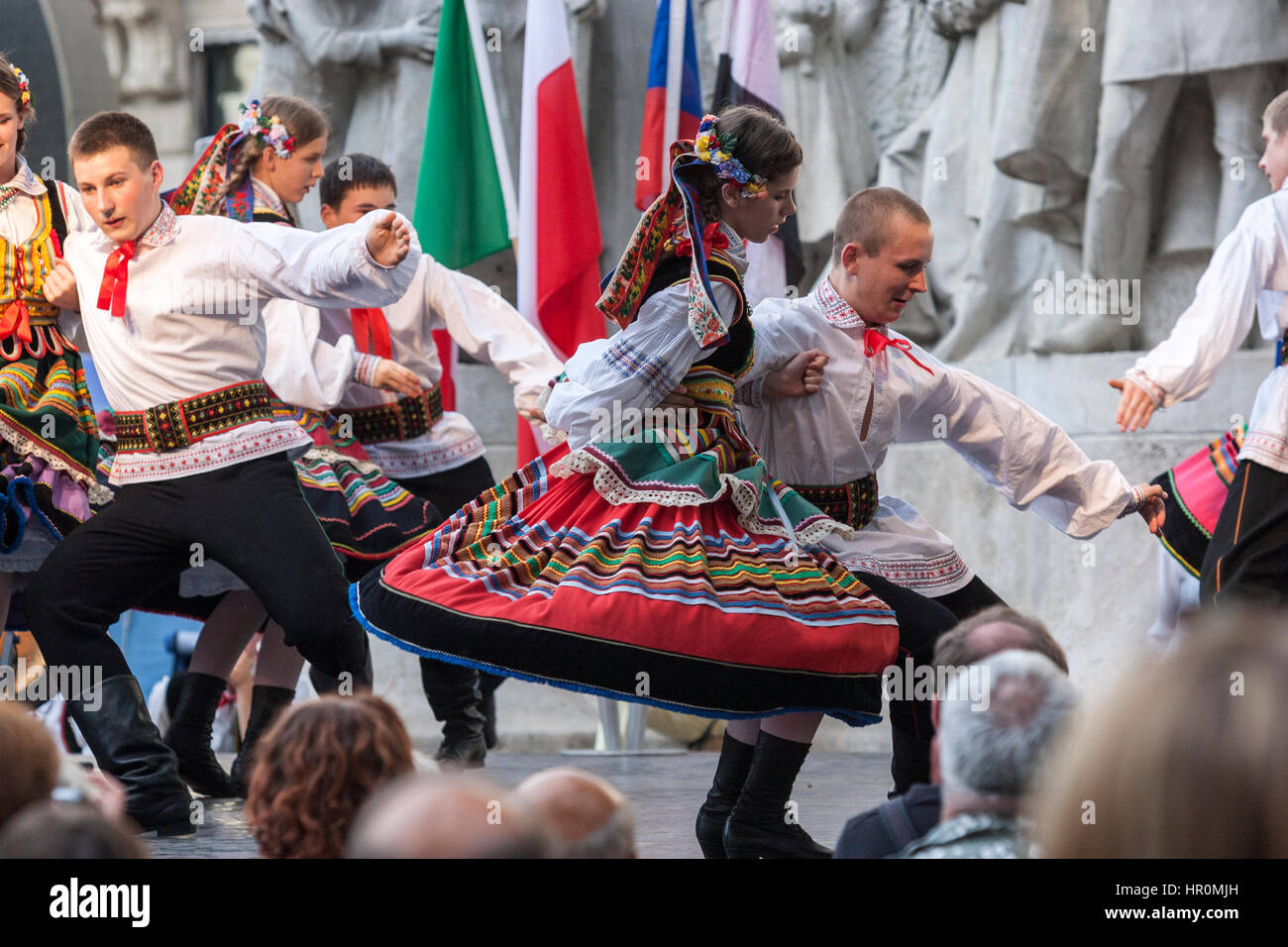 Boys and girls in folk costume performing a Hungarian folk dance in