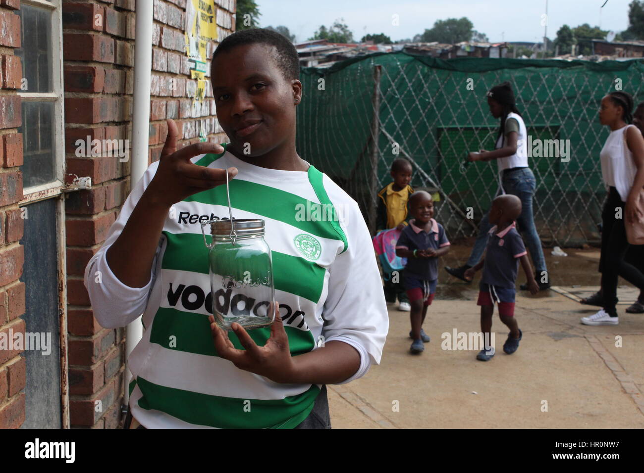 Johannesburg, South Africa. 06th Feb, 2017. A mother stands outside of