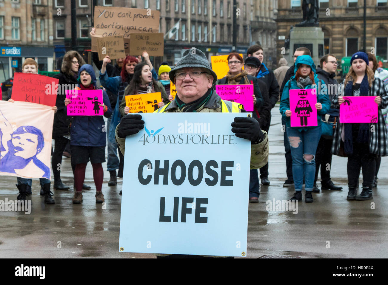 Glasgow, Scotland, UK. 25th Feb, 2017. '40 Days for Life', a Christian Pro-Life and anti abortion group held a prayer meeting in George Square, Glasgow, in preparation for 40 days of prayer, beginning on Ash Wednesday (1 March) and ending on Palm Sunday (9 April), hoping to have the Scottish Executive repeal the Abortion Act 1967. The prayer meeting was confronted by counter demonstration of activists promoting international womens' rights and advocating the 'Right to Choose' Credit: Findlay/Alamy Live News Stock Photo