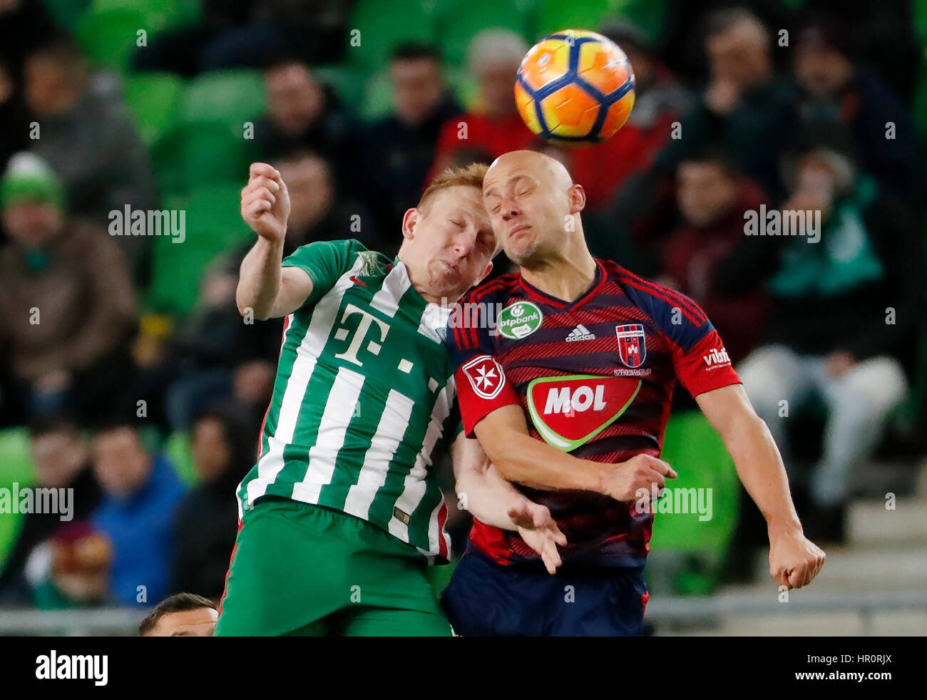 Budapest, Hungary. 25th February 2017. Laszlo Kleinheisler (L) of Ferencvarosi TC battles for the ball in the air with Jozsef Varga (R) of Videoton FC during the Hungarian OTP Bank Liga match between Ferencvarosi TC and Videoton FC at Groupama Arena on February 25, 2017 in Budapest, Hungary. Credit: Laszlo Szirtesi/Alamy Live News Stock Photo