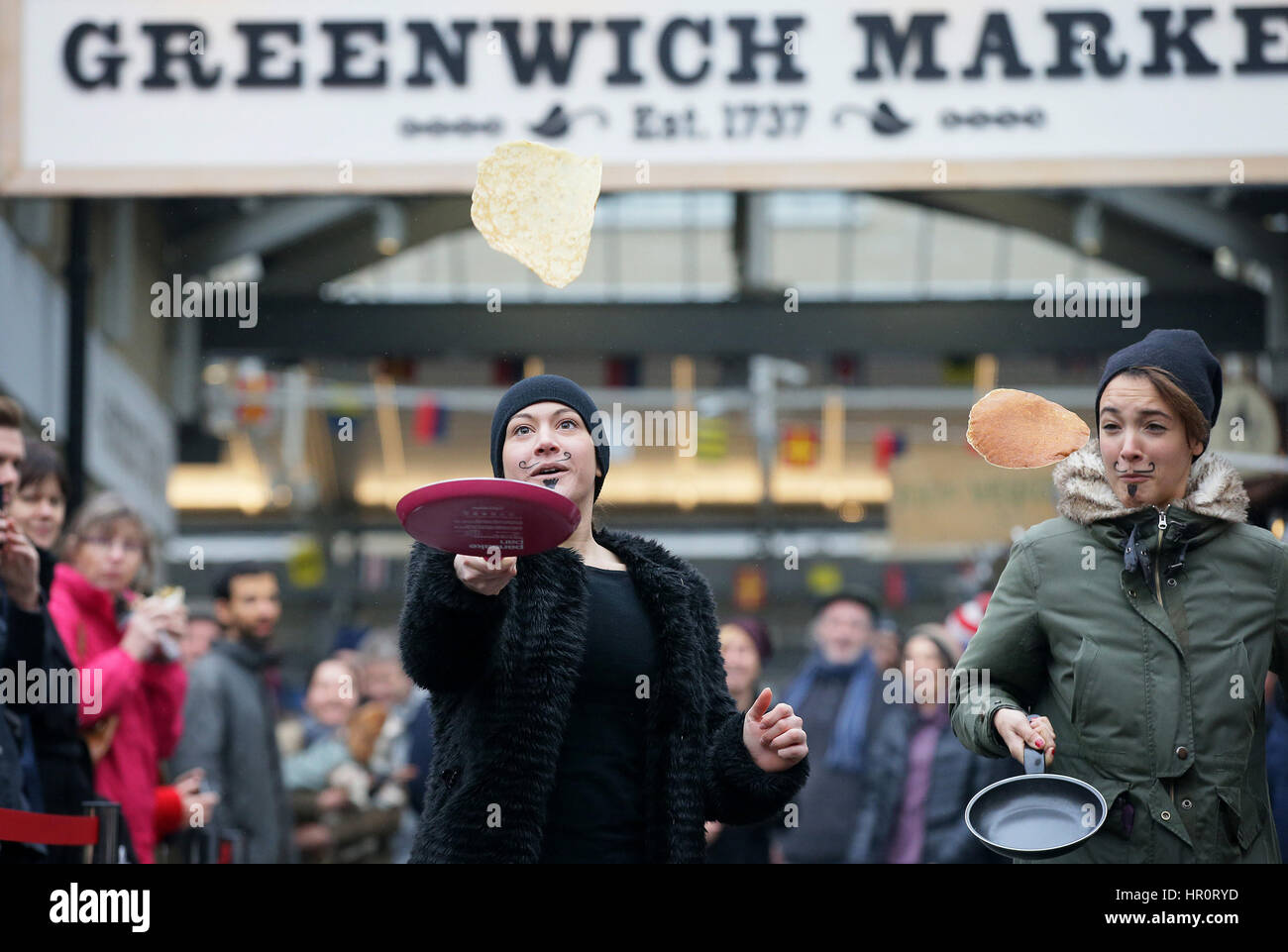 London, UK. 25th Feb, 2017. People take part in an annual Greenwich Market pancake warmup race, named the Big Flippin' Warm Up, ahead of the grand final to take place on Shrove Tuesday at Greenwich Market, in London, Britain, on Feb. 25, 2017. Credit: Tim Ireland/Xinhua/Alamy Live News Stock Photo