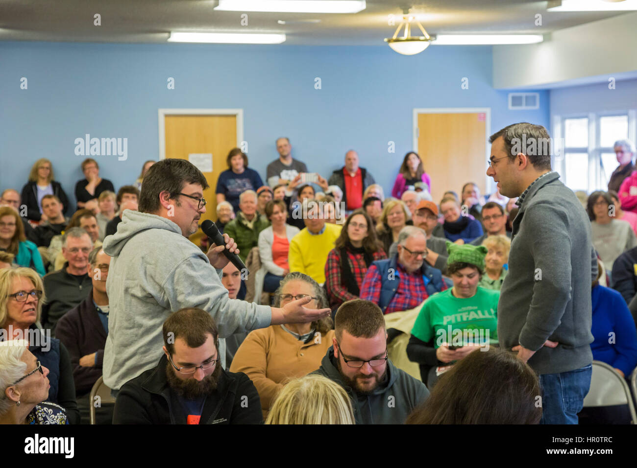Hastings, Michigan, USA. 25 February 20Hastings, Michigan, USA. 25 February 2017.17. Republican Congressman Justin Amash (right) listens to Eric Anderson, chair of the Barry County Democratic Party, during a town hall meeting for his constituents in Michigan's Third Congressional District. Many questioners expressed strong opposition to Republicans' plan to repeal the Affordable Care Act. Credit: Jim West/Alamy Live News Stock Photo