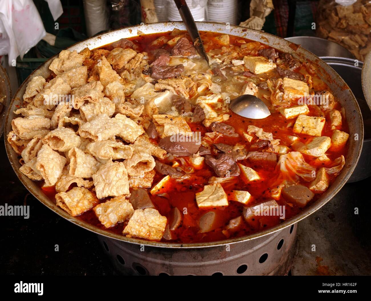 Outdoor vendor sells a spicy tofu stew with duck blood cakes Stock Photo
