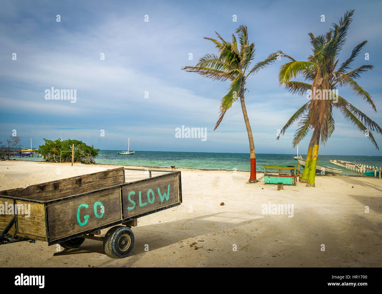 Wood Cart with Go Slow message at Caye Caulker - Belize Stock Photo
