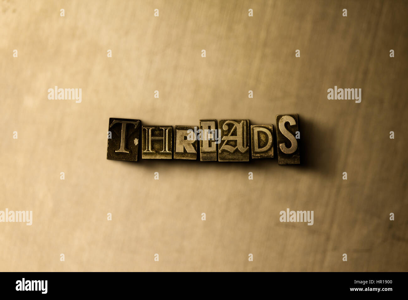 THREADS - close-up of grungy vintage typeset word on metal backdrop ...