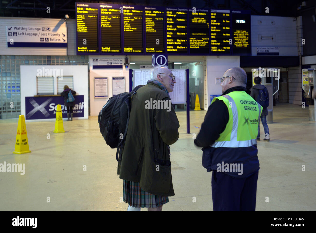 Queen Street station Glasgow tourists waiting for trains kilted customer with service staff Stock Photo