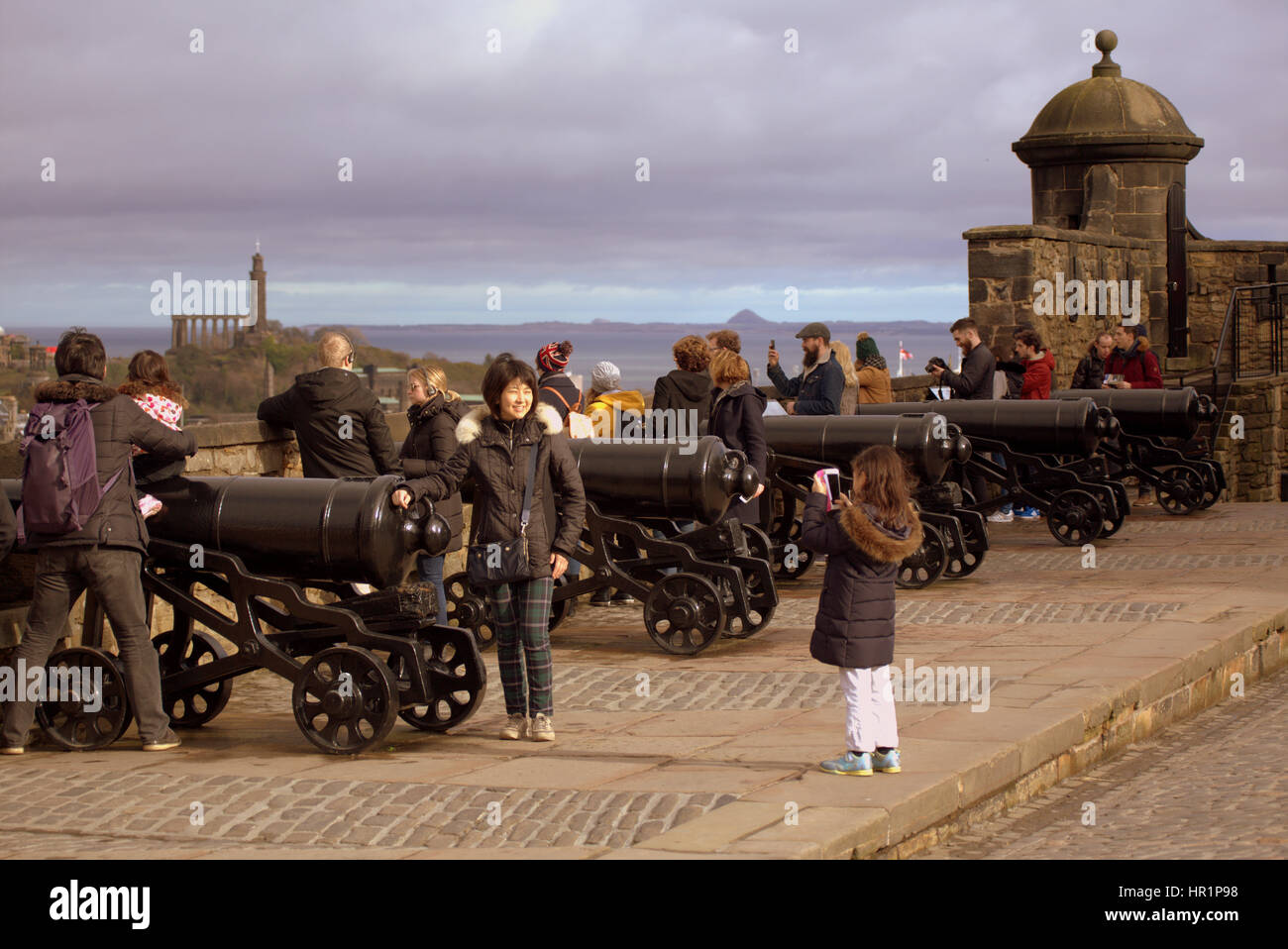 Edinburgh castle tourists on the ramparts inside the castle taking ...