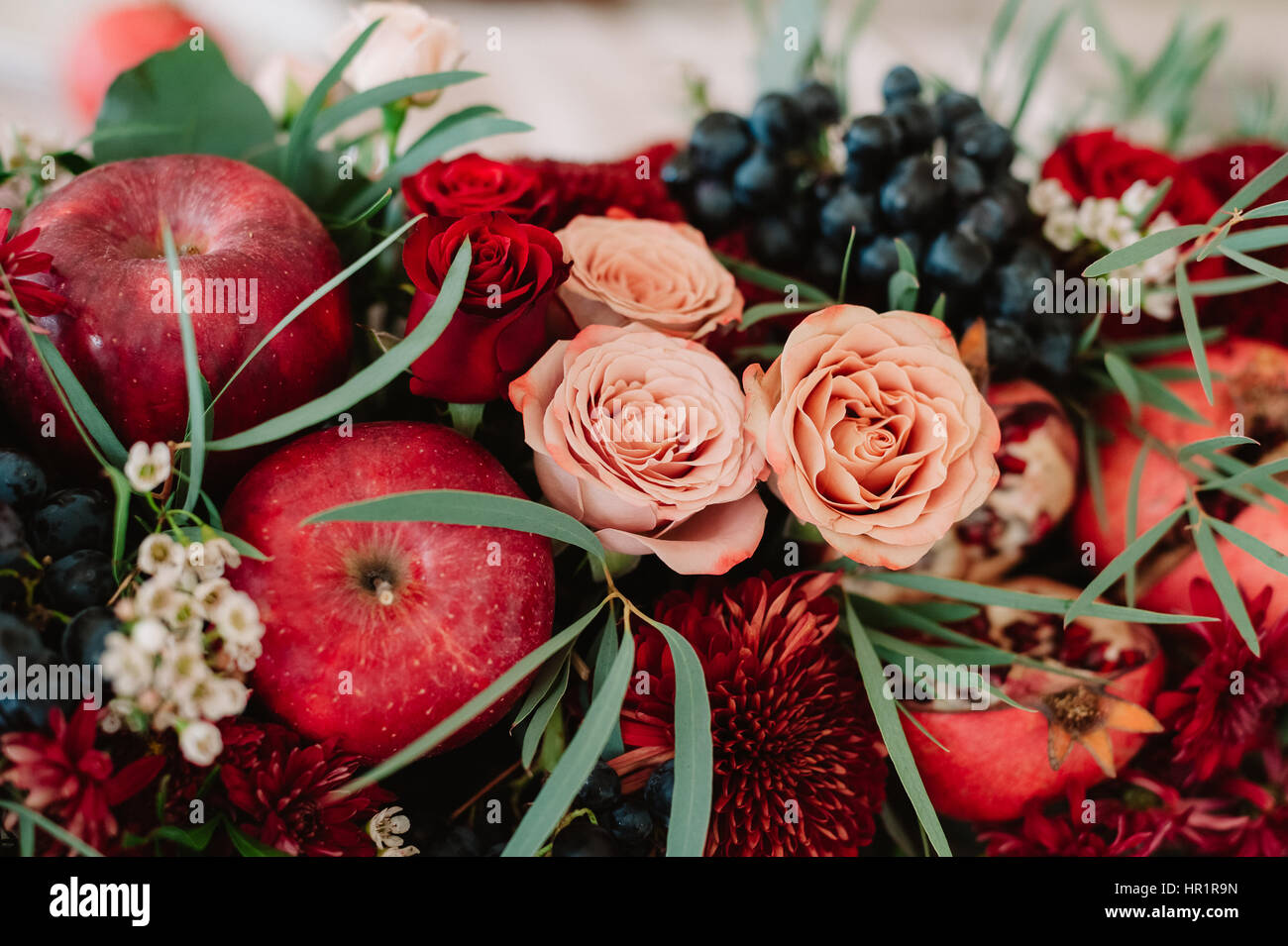 Autumnal wedding composition of roses, apples, grape and pomergranate ...
