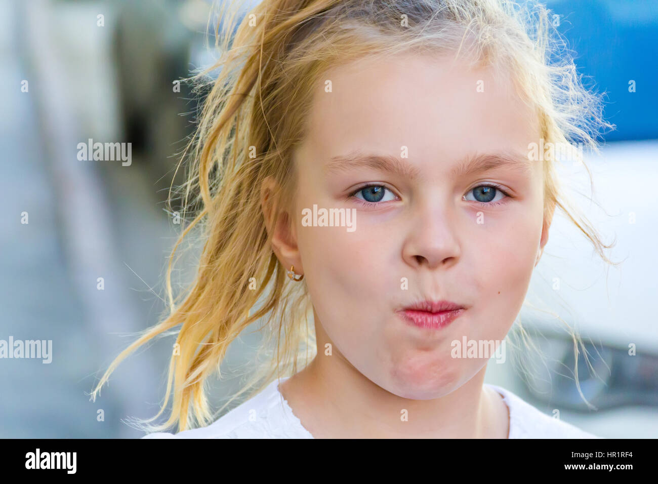 Cute girl with blond long hair and blue eyes Stock Photo - Alamy