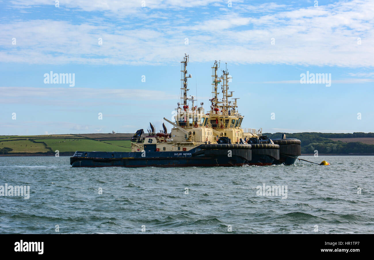 Three tugs on one mooring buoy at Angle Bay, Milford Haven, awaiting their next task in an idyllic location Stock Photo
