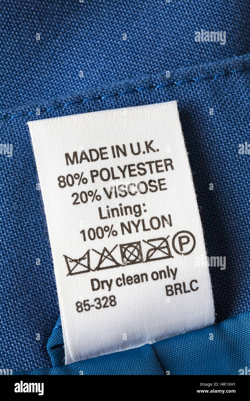 Care cleaning instructions label dry clean only in blue jacket made in UK 80% polyester 20% viscose lining 100% nylon Stock Photo