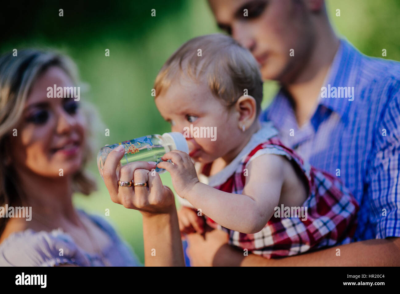 Happy mother, father and daughter in the park Stock Photo - Alamy