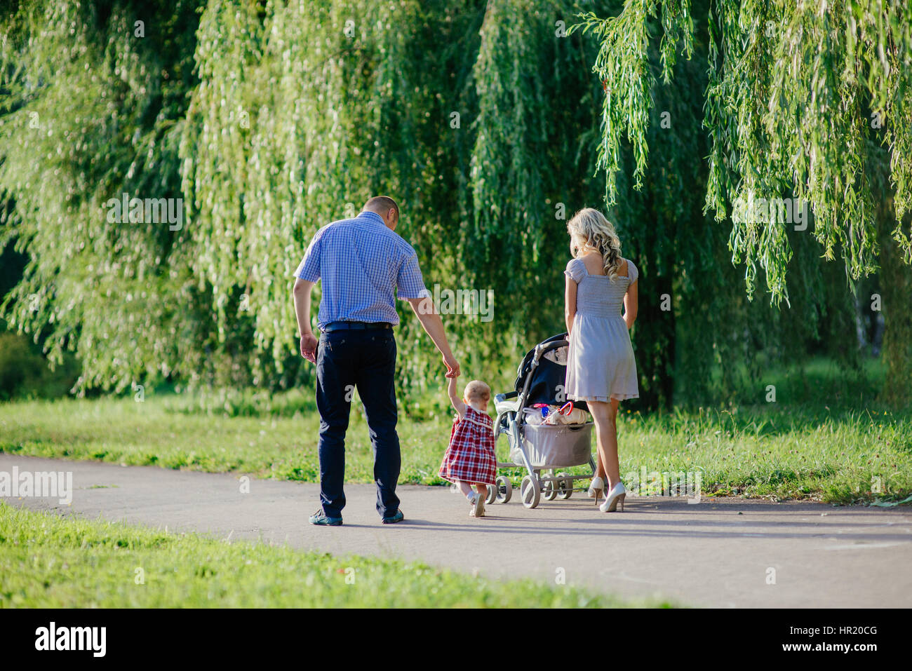Happy mother, father and daughter in the park Stock Photo - Alamy