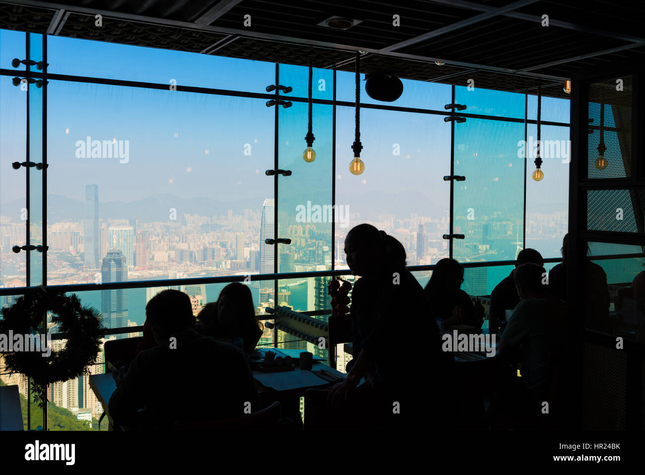 Silhouette of the people in the restaurant on Victoria Peak observation viewpoint, Hong Kong Stock Photo