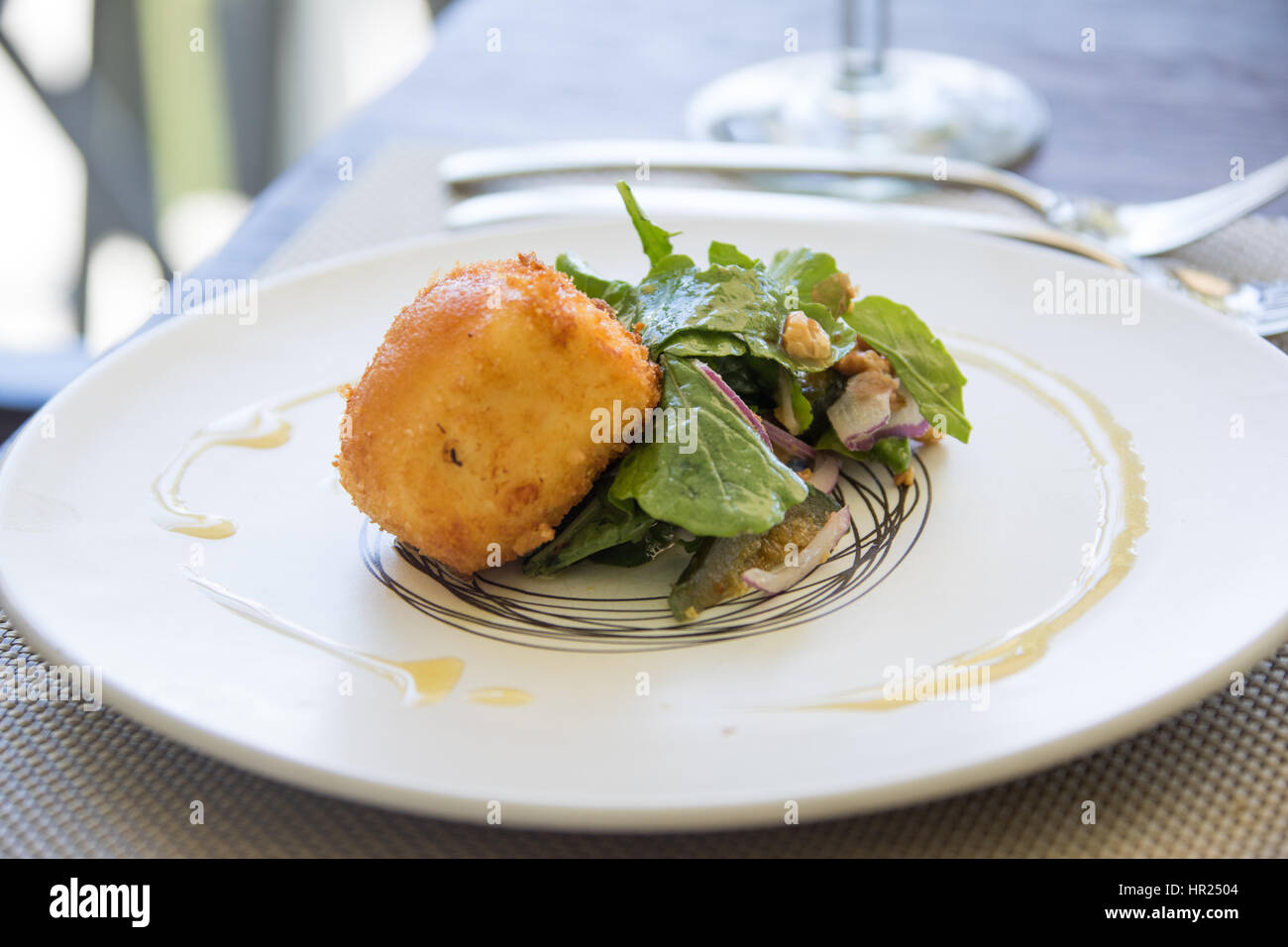 Crumbed Goats Chevre, fig preserve, rocket and walnuts at La Petite Ferme, Franschhoek, Cape Winelands, South Africa Stock Photo