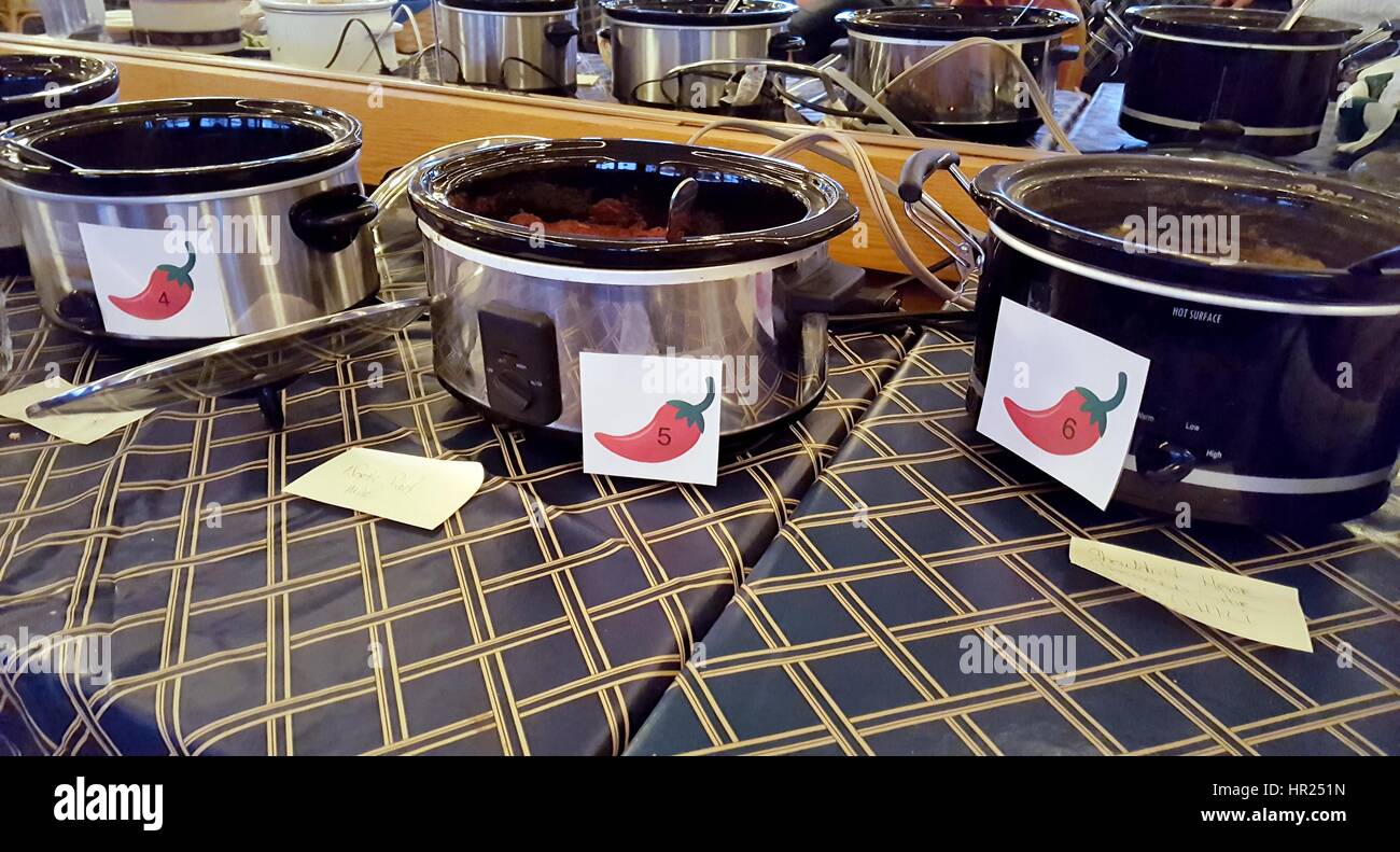 row of crock pots in chili cook off contest Stock Photo