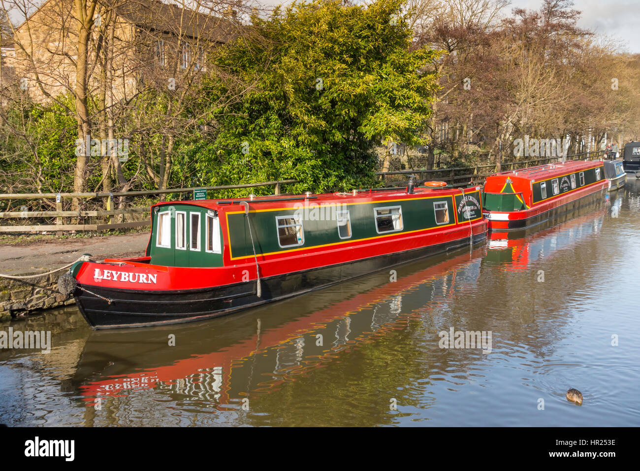 Two brightly painted canal narrow boats on the Leeds-Liverpool canal near the town centre  in Skipton  North Yorkshire Stock Photo