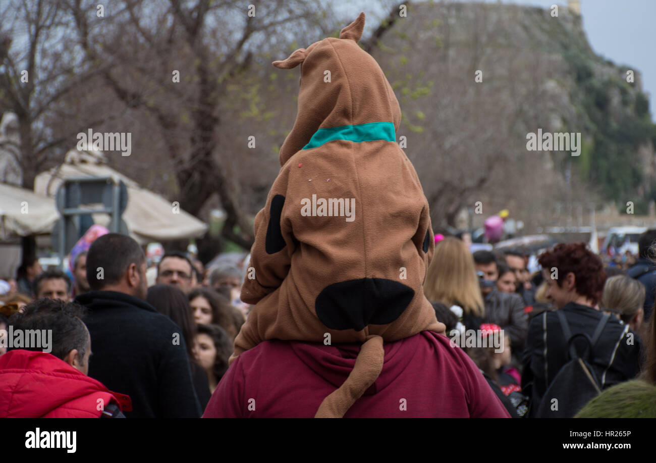 Carnival celebrations in Corfu Greece.kid dressed as scooby doo having a piggy back ride to enjoy the view. Stock Photo