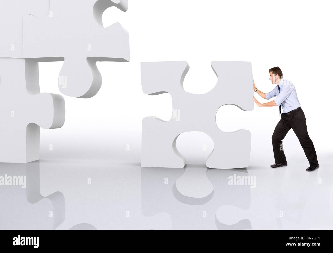 business man building a 3d puzzle over white Stock Photo
