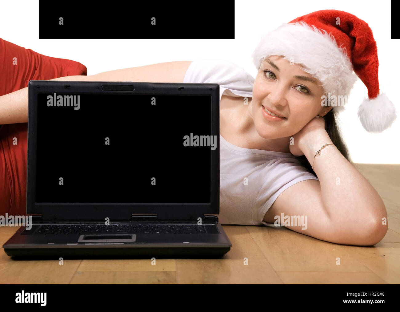 Beautiful girl with a laptop lying on the floor Stock Photo - Alamy