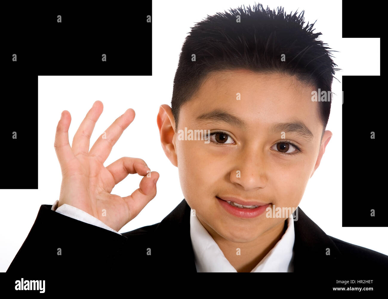 business boy doing the ok sign with his hand over a white background ...