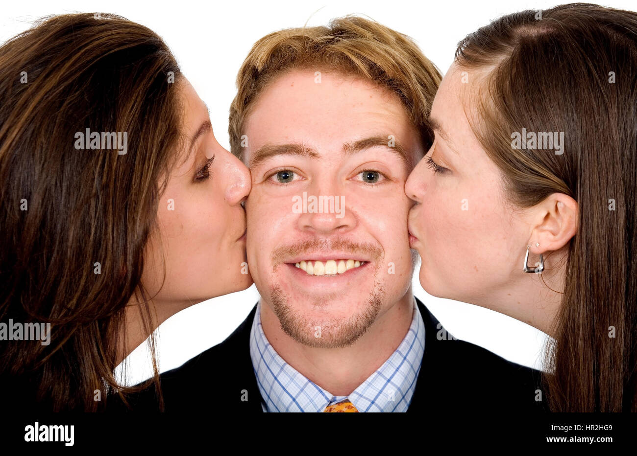 Business man with two girls kissing him at the same time isolated over a white background Stock Photo