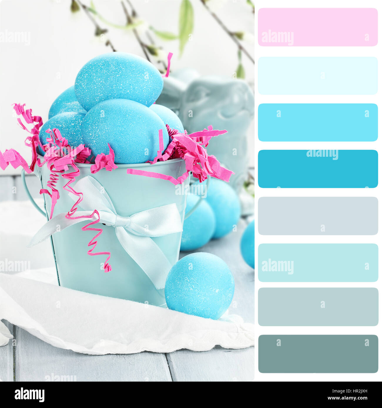 Blue Easter eggs in a blue tin bucket with color palette. Stock Photo