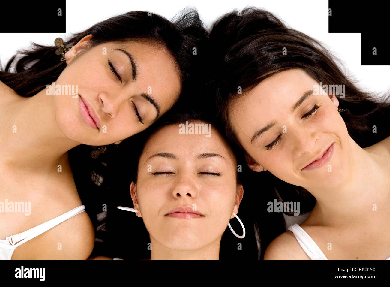 group of friends sleeping with their heads together on the floor